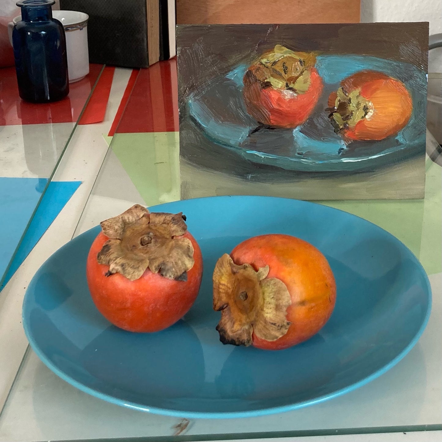 Small stilllife with persimmons on blue